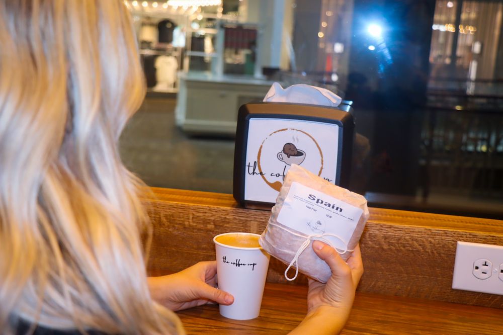 Customer with coffee and sandwich